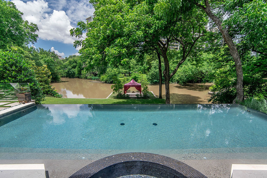 The infinity-edge pool overlooks Turtle Creek, and the property's tented-gazebo.