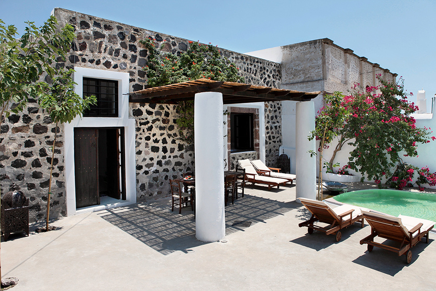 The exterior wall of Santorini Stone House is decorated with volcanic rock.