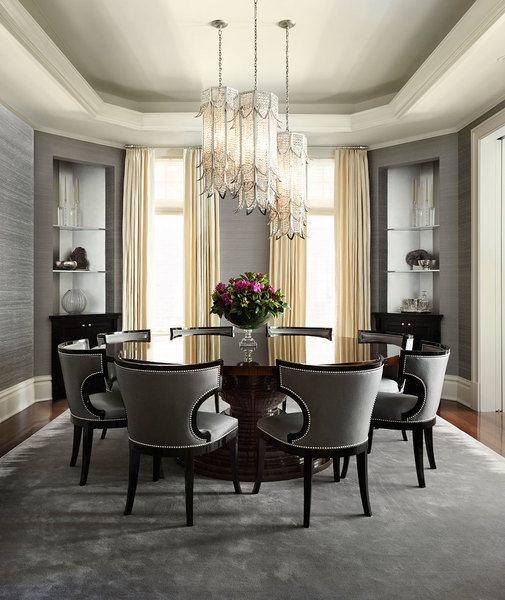 A round table takes center stage in a dining room designed by Joan Craig to make entertaining effortl