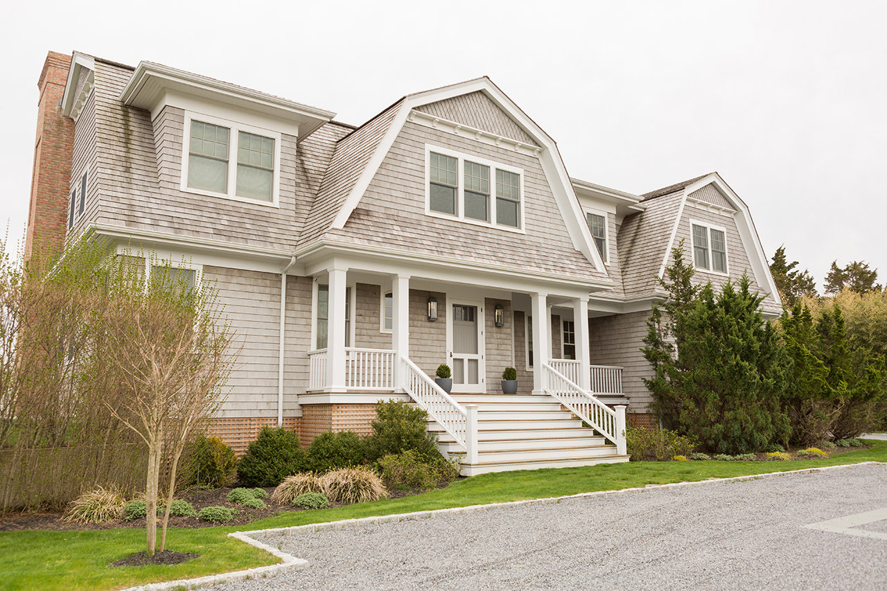 Designed by Lauren Behfarin, this stately home’s small front porch gives a refined appearance that’s