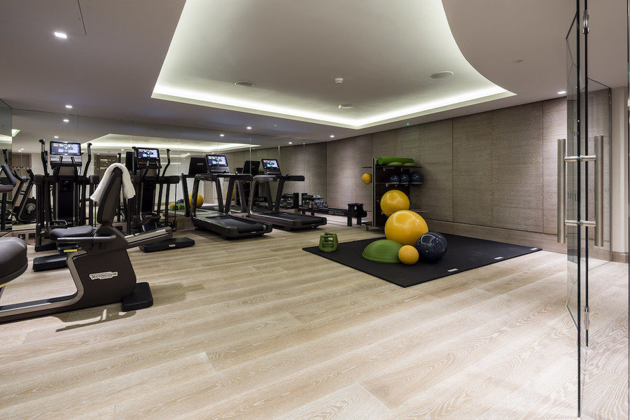 Soaring double-height windows lend light and an open feel to this airy gym designed by Kari Whitman.