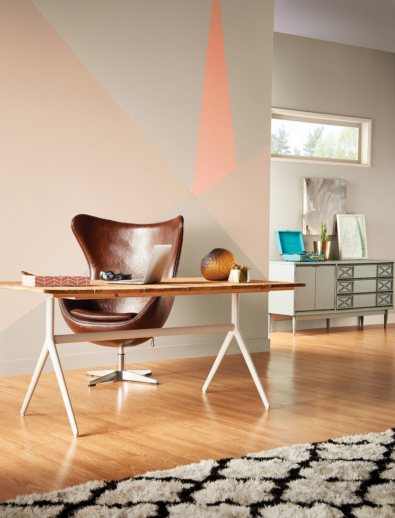 An accent wall is even more interesting thanks geometric shape in gradations of neutral shades and a